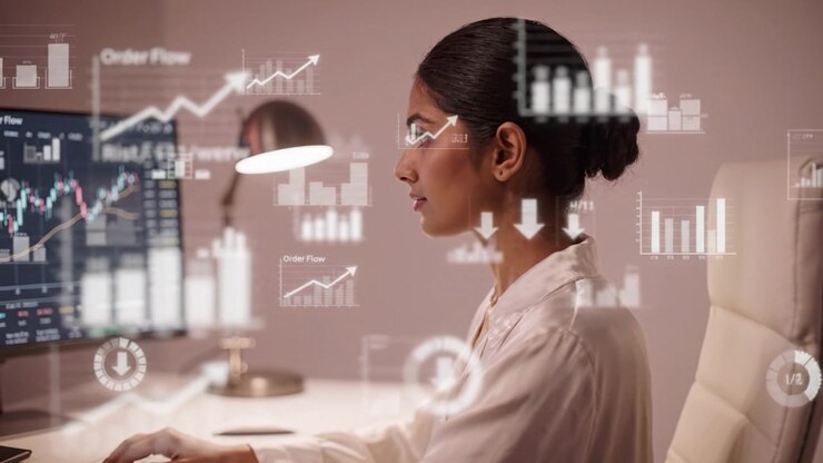 Focused Professional Analyzing Stock Market Trends and Data Charts on Computer Screen in Modern Workspace for Financial Insights and Investment Decisions