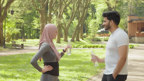 couple enjoying a break after exercising in a park