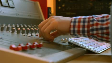 student mixing music in the studio