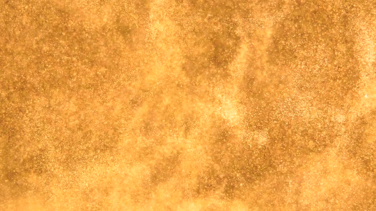 elegantes, detalladas y doradas partículas fluyen con poca profundidad de campo bajo el agua