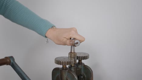 woman operating a vintage mechanical machine