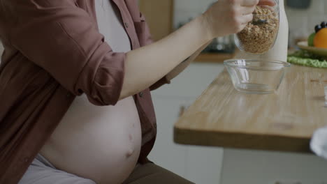 pregnant woman eating granola