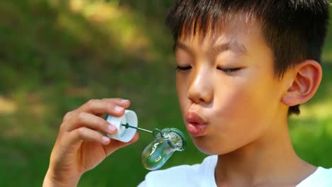 Boy-blowing-bubble-with-wand