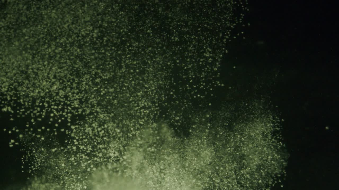 A big cloud of white powder falling trough water in slow motion.