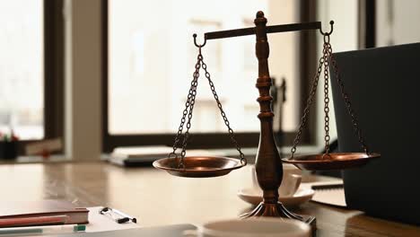 attorney office with scales of justice on a desk, background of law firm with copy space and no people