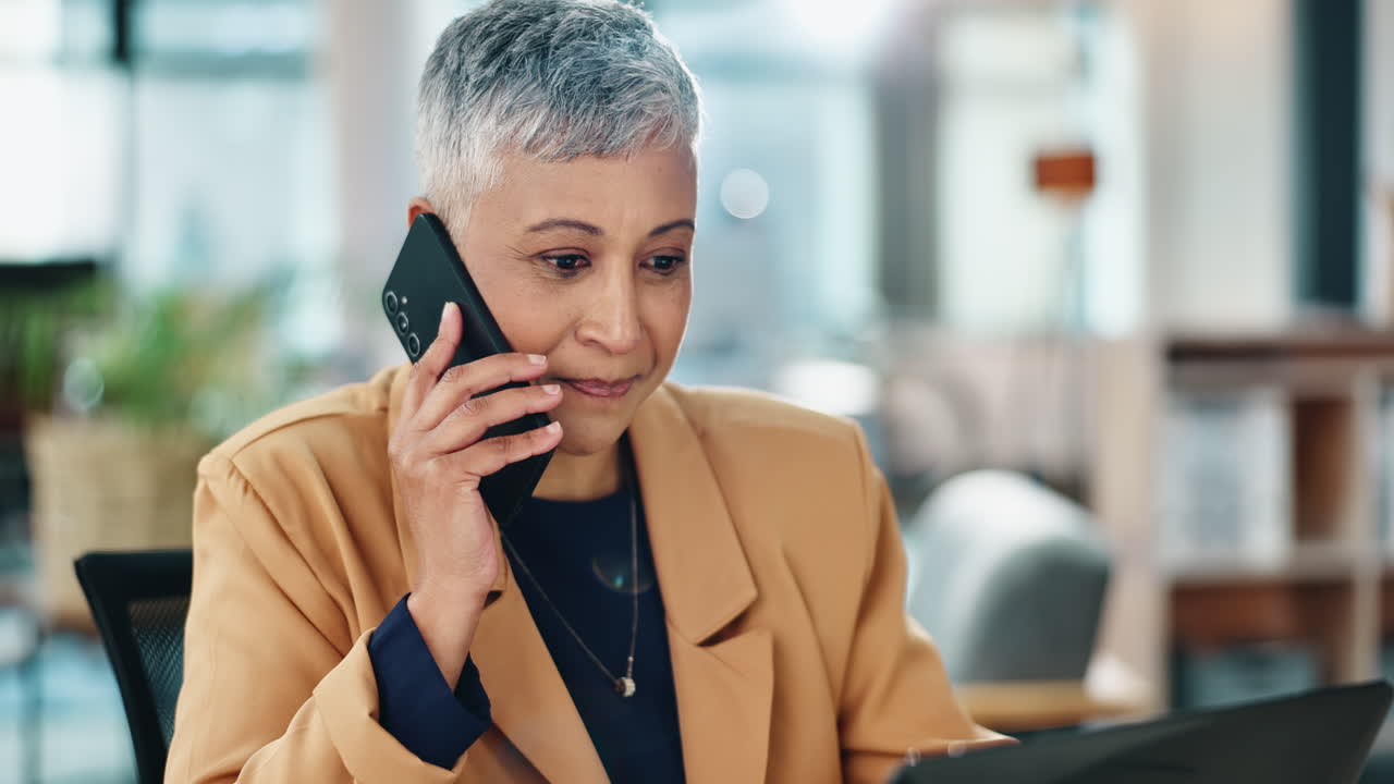 A businesswoman talking on the phone in her office