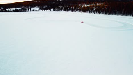 Sports-car-is-driving-on-a-frozen-lake-in-the-arctic-circle