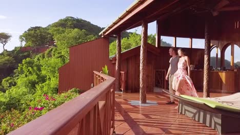 A-Romantic-Man-And-Woman-Couple-On-Vacation-Toasting-Drink-On-The-Balcony-Of-A-Luxury-Resort-Hotel-Room-In-St-Lucia-Caribbean-Islands-2