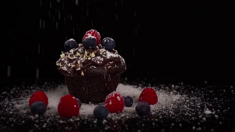 close-up shot of a chocolate muffin with red fruits all around while powdering white sugar in slow motion