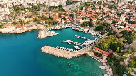 Breathtaking aerial view of Kaleici Marina and Old Town, Antalya, Turkey. A serene Mediterranean aerial pan showcasing historic charm and vibrant seaside beauty.
