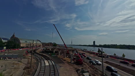 construction of railway tracks and station in city by river in latvia