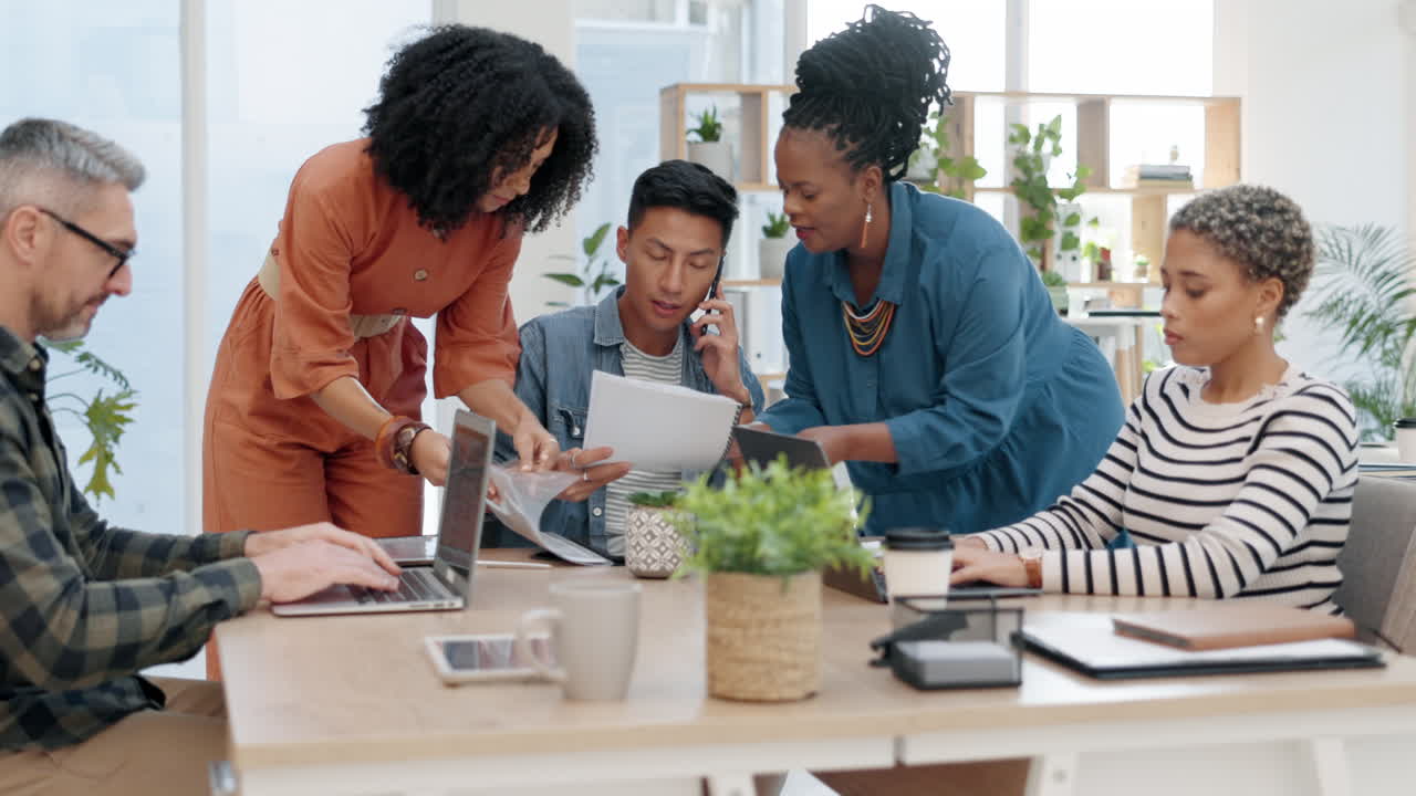 Group, chaos and Asian man multitasking paperwork