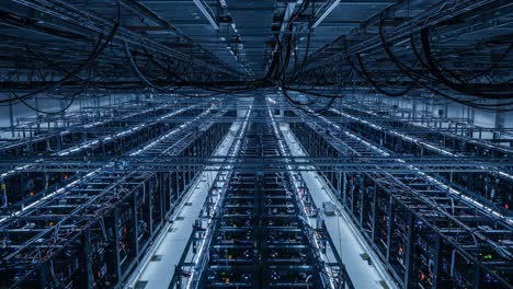 aerial view of a massive data center featuring rows of server racks and intricate network cabling in a modern, technologically advanced facility