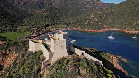 castle overlooking mountain lake in corsica