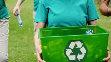 family collecting litter in park