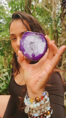 woman holding a purple agate slice