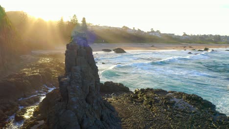 cathedral rocks with ocean waves on jones beach at sunset in kiama downs, nsw, australia