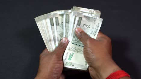 a man counting indian rupees