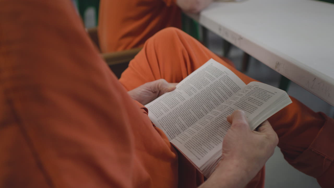 Inmate Reading Bible in Prison Cell – Faith and Reflection During Incarceration