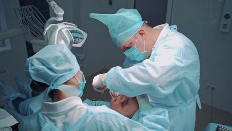 dentist during a dental intervention with a patient. dental clinic concept.