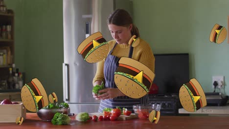 la animación de los iconos de las hamburguesas sobre la cocina de la mujer caucásica.