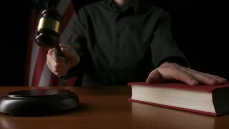 judge with gavel and book in courtroom