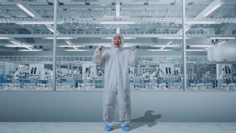 factory worker celebrating success with robots