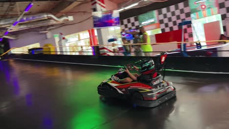 kid go-karting in an indoor arcade