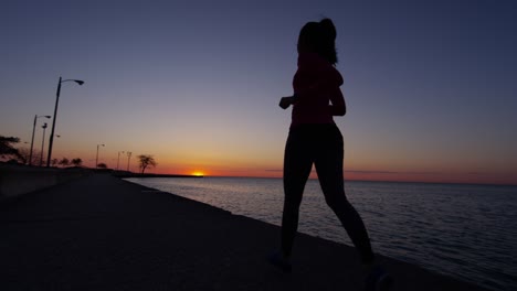 hispanic female silhouette running at sunrise in chicago