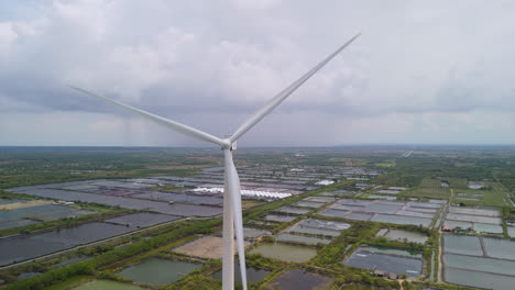 aerial flying over renewable energy wind farm wind turbines