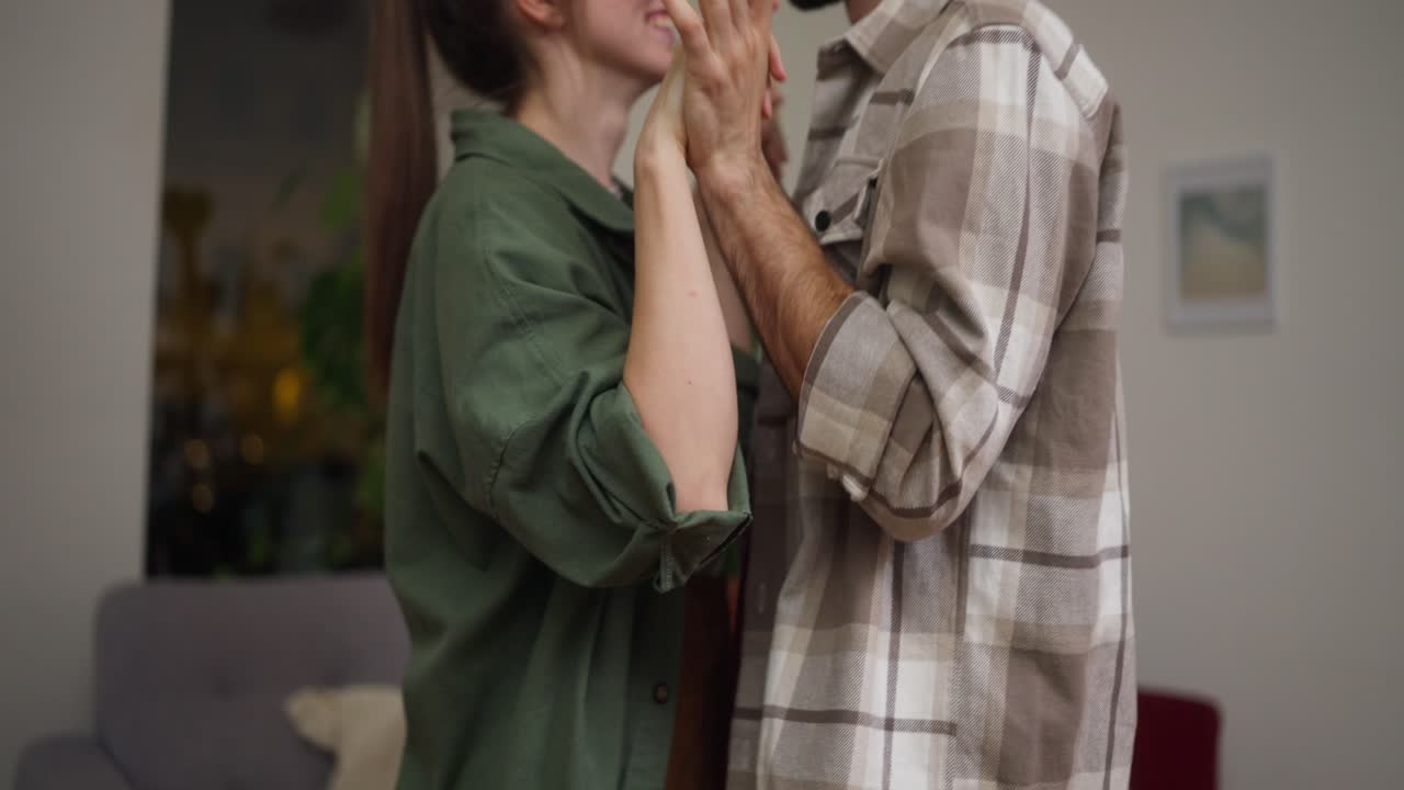 Couple hugging and showing affection at home