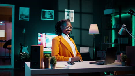 Portrait-of-university-student-sitting-at-desk-using-laptop-to-do-school-tasks