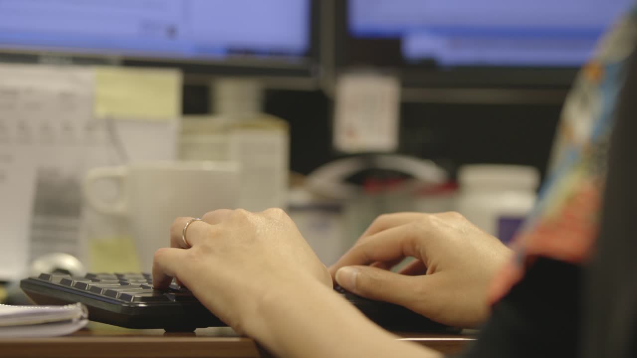 Woman Typing on Keyboard at Office Desk