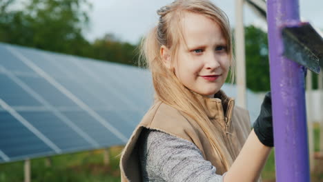 a child paints poles at a home solar power plant