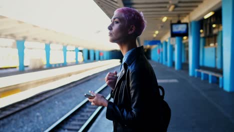 woman using mobile phone while waiting for train 4k