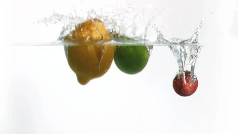 fruits falling into water in super slow motion