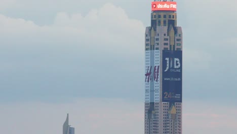 sikorsky uh-60 black hawk helicopters fly in front of baiyoke sky hotel in bangkok, thailand