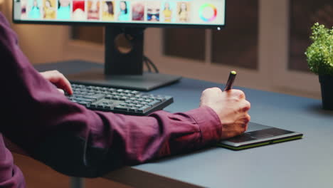 close up of photographer using graphic tablet to retouch photos