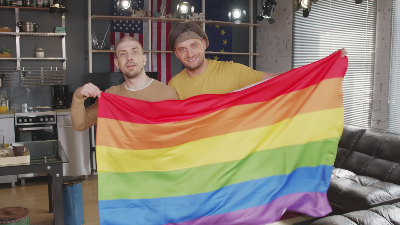 Portrait of Gay Couple with Rainbow Flag