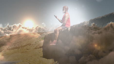 animation of glowing light over senior man using smartphone sitting on rock