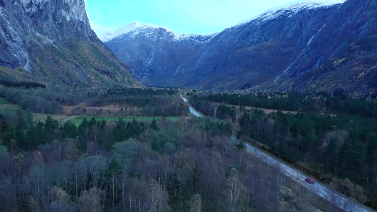 Luftfoto av alpedal med elv, vei og fjell