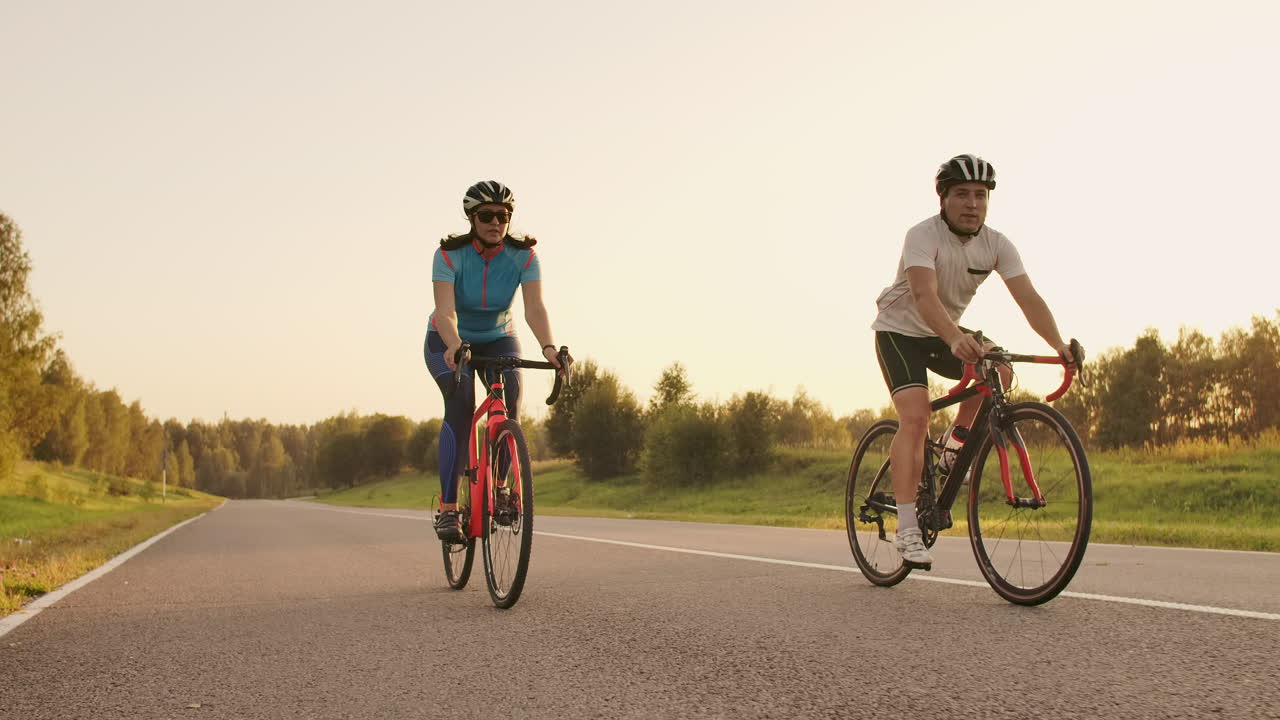 Tracking shot of a group of cyclists on country road. Fully released for commercial use.