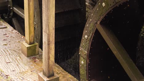 close up on the bottom section of two hydraulic wheels from a water mill