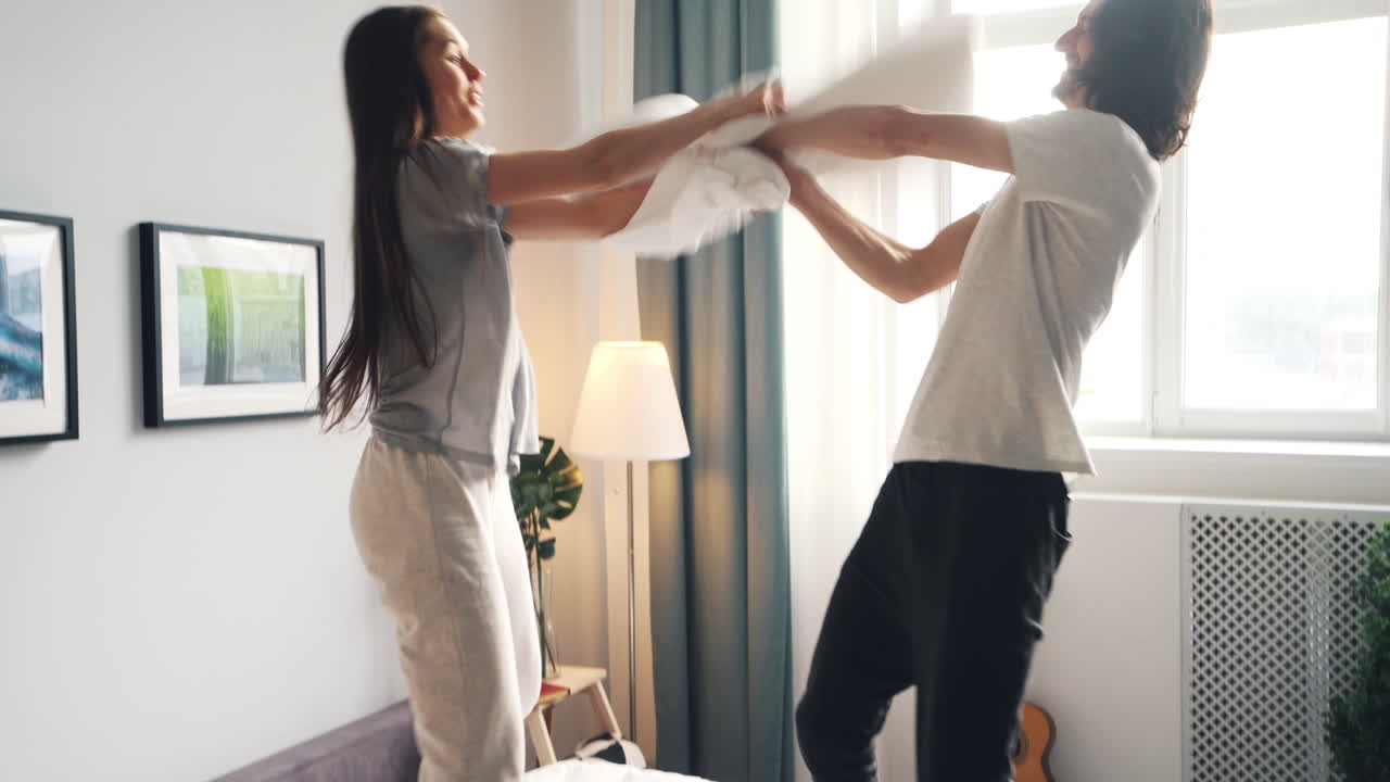 Happy Couple Pillow Fight and Kissing
