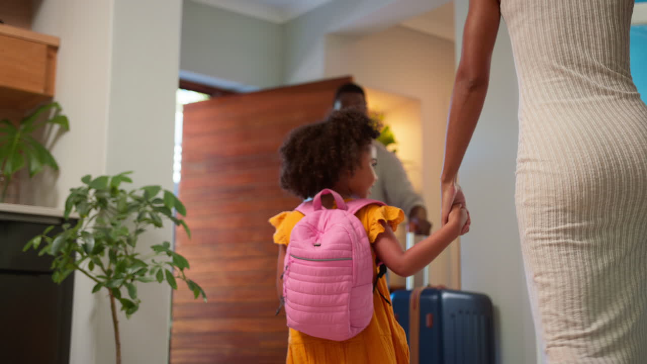 Family By Door With Suitcases Leaving Home For Holiday Or Vacation