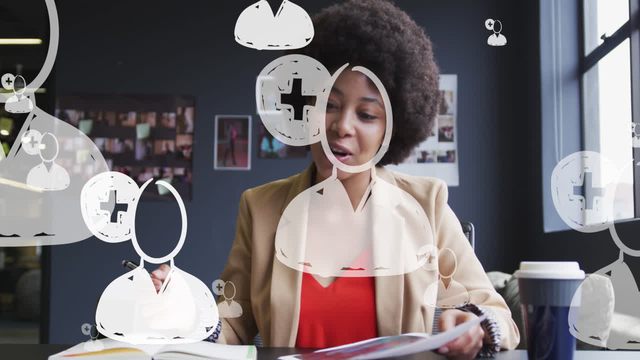Animation of media icons over african american businesswoman having video call and smiling