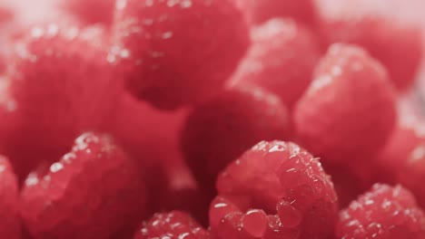 micro video of close up of raspberries with copy space