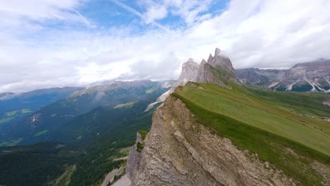 fpv drone flying close of the sharp mountain cliffs of seceda, italy, dolomites mountains in the alps