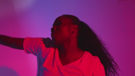 Studio-Shot-Of-Young-Woman-Dancer-Dancing-Against-Blue-And-Pink-Lit-Background-4