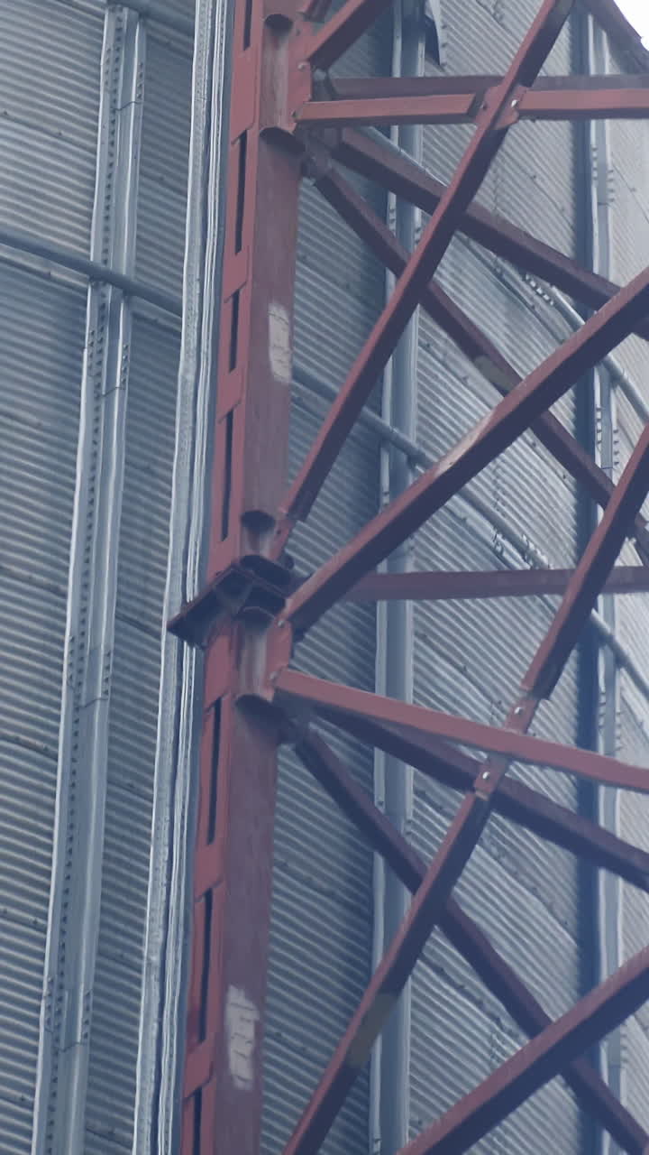 Industrial agriculture farming equipment. Big steel elevator construction storage. Vertical video